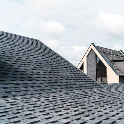 Architectural asphalt shingle roof covering a steep residential roof slope