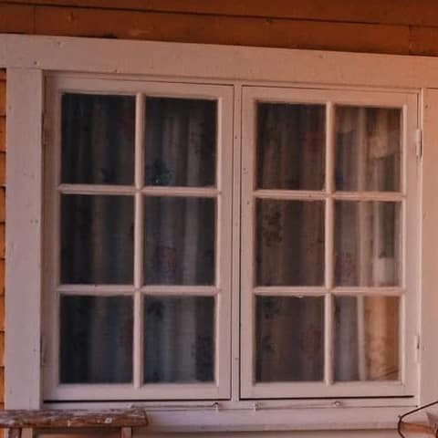 Framed multi-pane glazed unit set into a building, with its surround